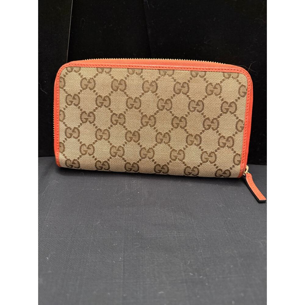 Gucci GG Canvas Zip-Around Wallet in tan with orange leather 8x4.5” like new